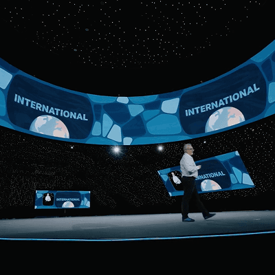Executive keynote stage featuring the Global Compliance Dashboard